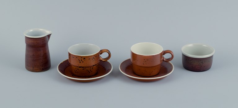 Stig Lindberg for Gustavsberg, COQ, two coffee cups with saucers, cream jug and sugar bowl.