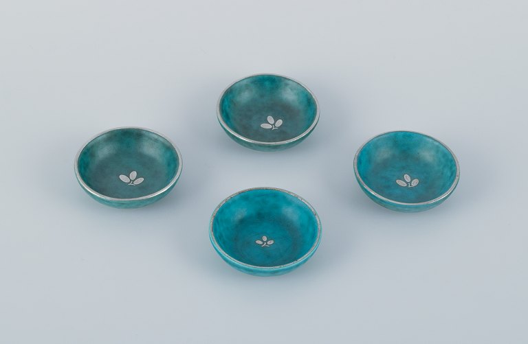Wilhelm Kåge for Gustavsberg, a set of four small Argenta ceramic bowls inlaid with silver leaf motifs.