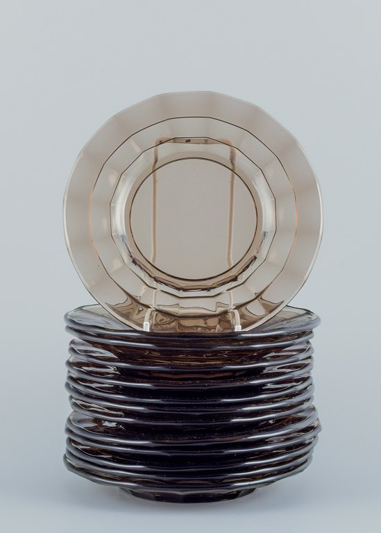 Simon Gate (1883-1945) for Orrefors/Sandvik, Sweden.A set of thirteen small Art Deco plates in smoked coloured pressed glass.