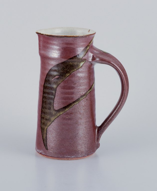 Stouby Keramik, Denmark, a handmade ceramic jug with glaze in brown and sandy tones.