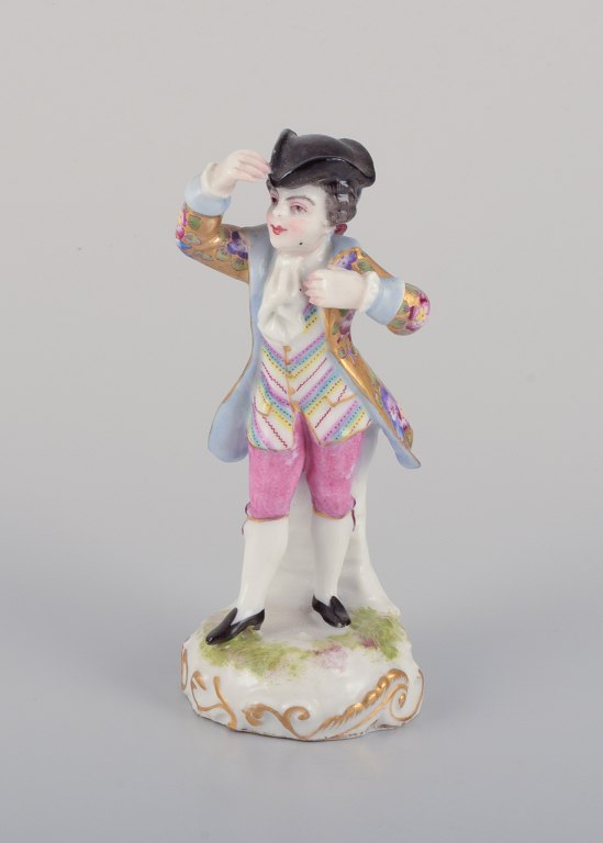 Meissen, Germany, porcelain figurine of a young man in elegant attire. Hand-painted in polychrome colors.