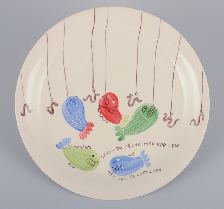 Stig Lindberg for Gustavsberg. "Löja" plate. Hand-painted with a fish motif. Satirical illustration with Swedish text.