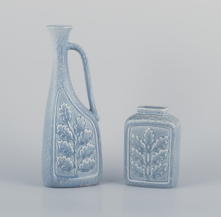 Rörstrand, Sweden. Large pitcher/vase and a smaller vase in ceramic. Branches with relief leaves. Glaze in light blue tones.