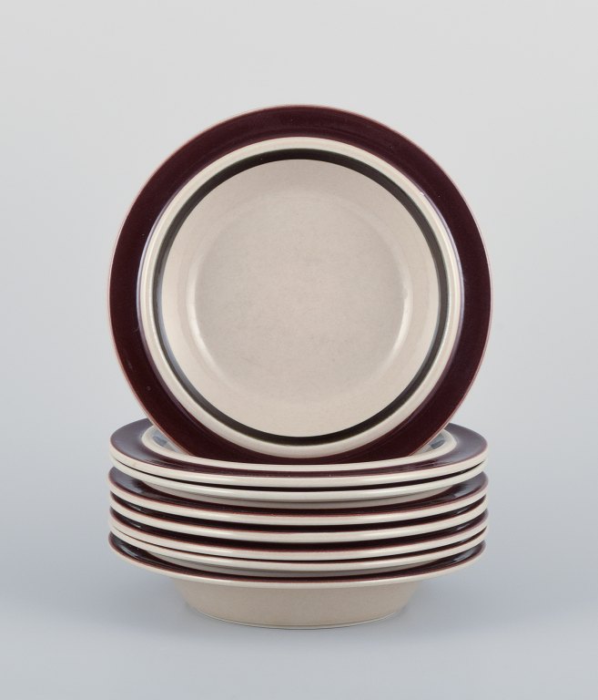 Raija Uosikkinen and Ulla Procopé for Arabia, Finland. A set of eight "Ruija" deep plates in stoneware with brown decoration.