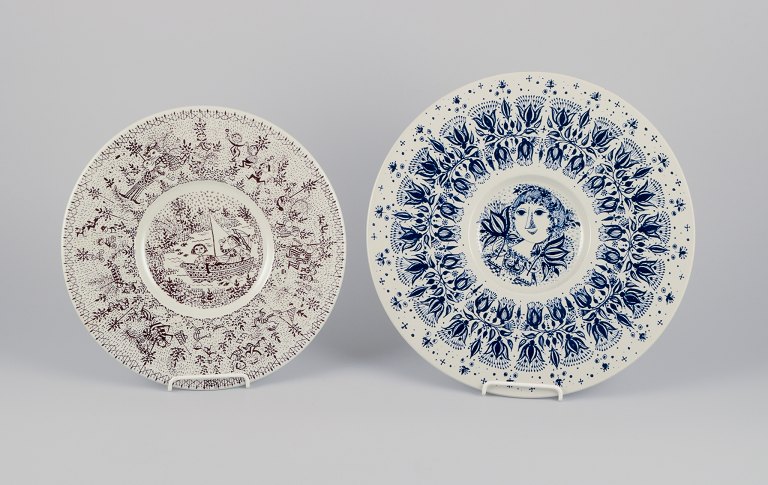 Bjørn Wiinblad for Nymølle, Denmark. Two large faience dishes with classic Wiinblad motifs in blue and brown.