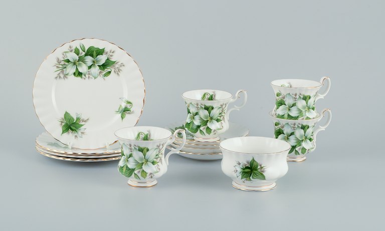 Royal Albert, England. A set of four "Trillium" coffee cups with saucers, cake plates, and a sugar bowl. Decorated with flowers and gold trim.