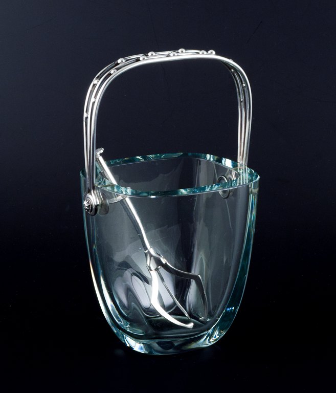 E. Dragsted, Danish silversmith.Danish design. Modernist ice bucket in art glass with a sterling silver handle and a silver-plated metal ice tong.Sleek Danish design.