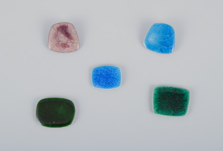 Ole Bjørn Krüger (1922-2007), Danish sculptor and ceramicist.Five unique brooches in glazed stoneware in blue, green, and purple hues.