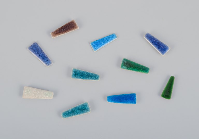 Ole Bjørn Krüger (1922-2007), Danish sculptor and ceramicist.Ten unique brooches in glazed stoneware in blue, white, purple, brown, and green hues.