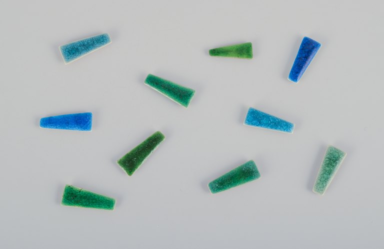 Ole Bjørn Krüger (1922-2007), Danish sculptor and ceramicist.Ten unique brooches in glazed stoneware in blue and green hues.