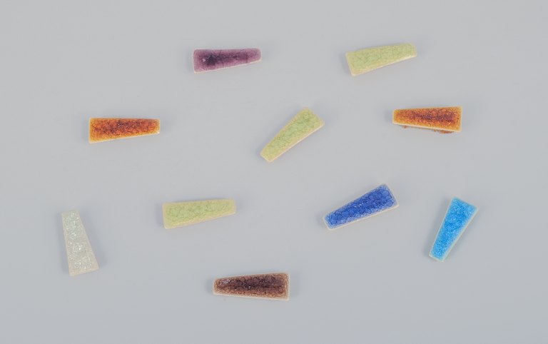 Ole Bjørn Krüger (1922-2007), Danish sculptor and ceramicist.Ten unique brooches in glazed stoneware in various colors.