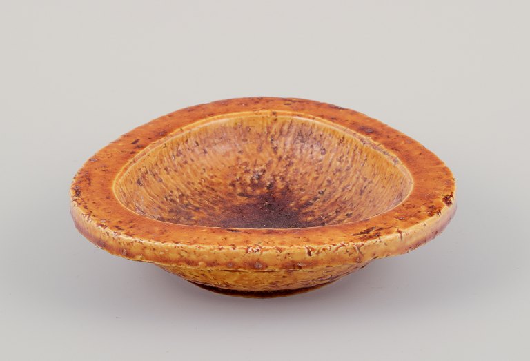 Gunnar Nylund for Rörstrand.Ceramic bowl with glaze in ochre yellow shades.
