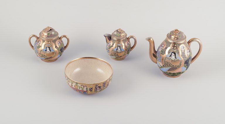 Satsuma, Japan. An egoist tea set consisting of a teapot, sugar bowl, creamer, and cup.