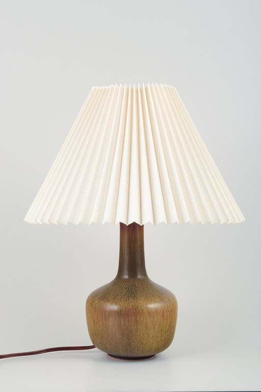 Eva Stæhr-Nielsen (1911–1976) for Saxbo, Denmark.Ceramic table lamp with pleated Le Klint lampshade.