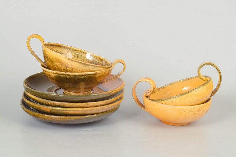 Kähler, set of four teacups with matching saucers.