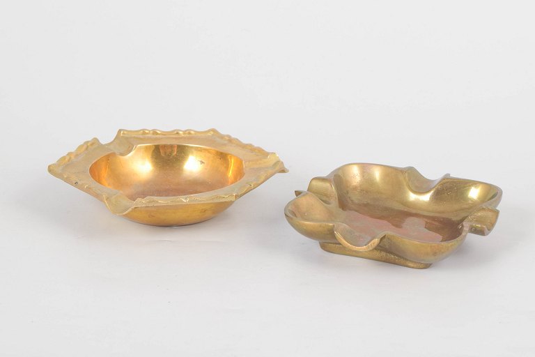 Two brass ashtrays.